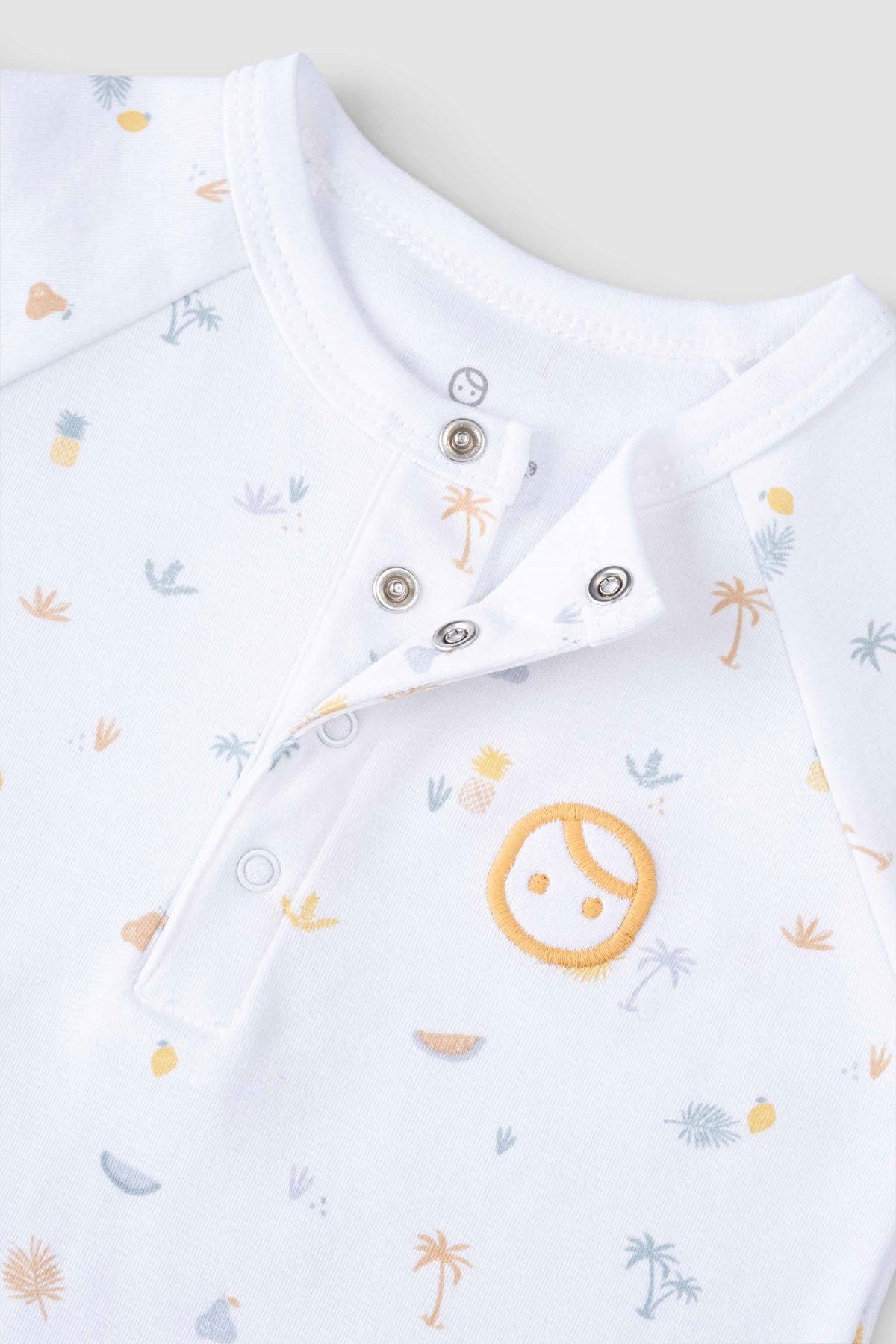 organic baby romper snap button detail close up
