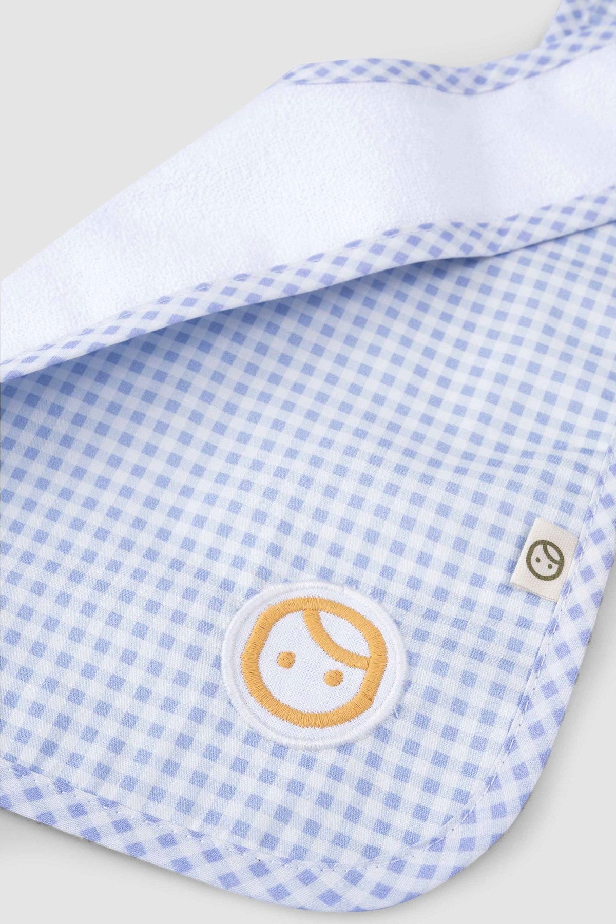 organic cotton baby bib detail logo embroidery blue picnic fabric