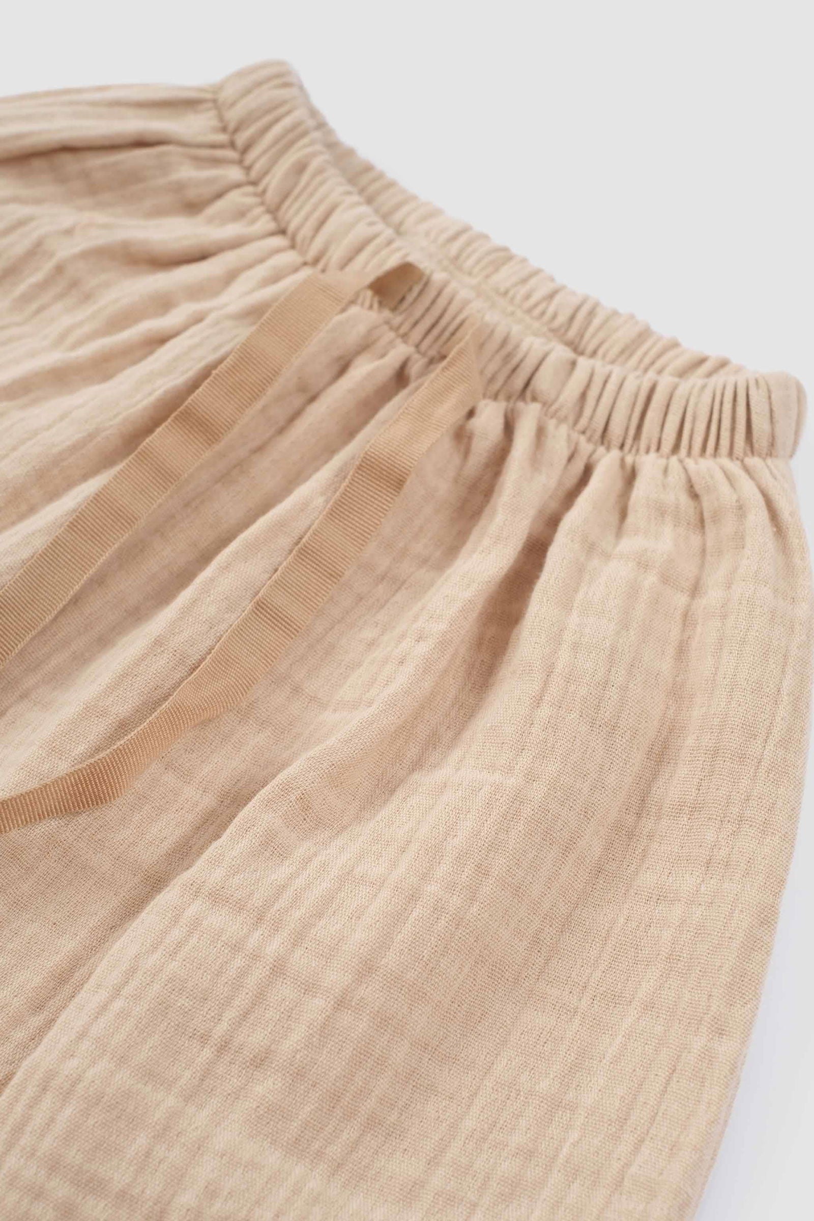 beige muslin baby pants elastic waist detail