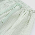 baby wearing organic muslin set green
