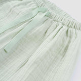 baby wearing organic muslin set green
