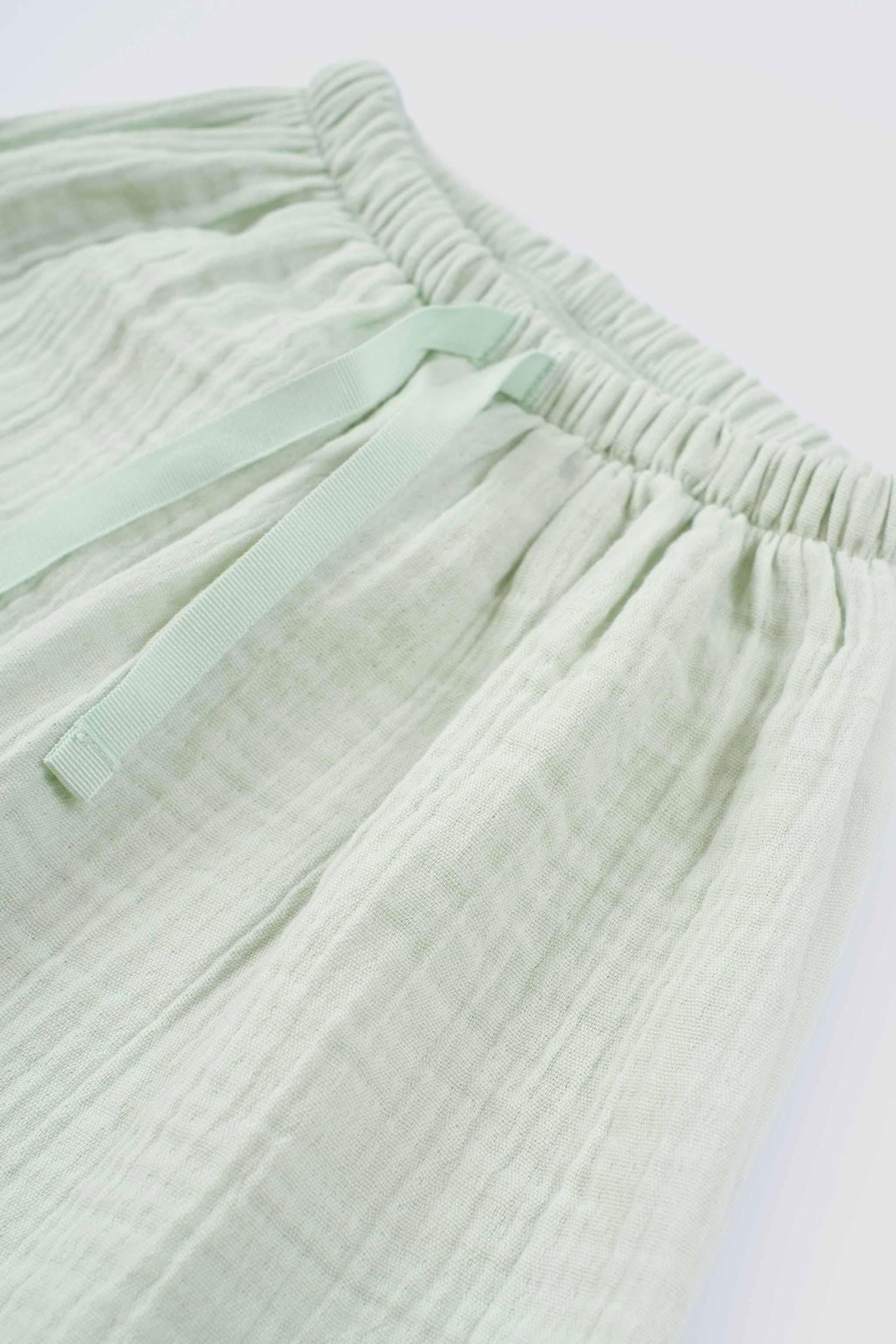 baby wearing organic muslin set green
