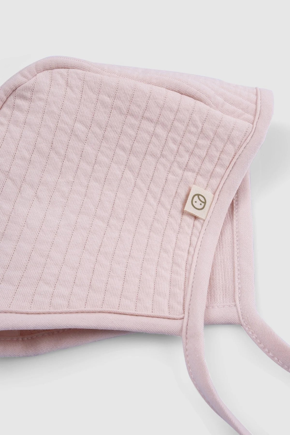 pink ribbed baby bonnet organic cotton textured hat detail