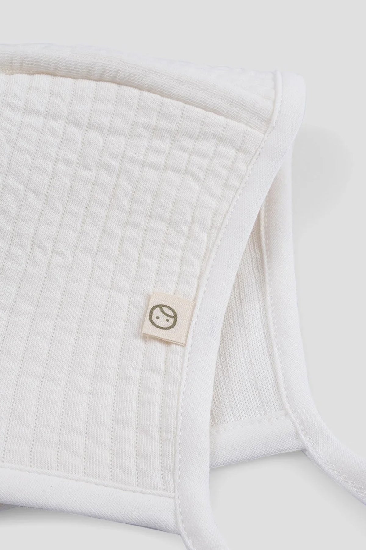white ribbed baby bonnet organic cotton textured hat detail